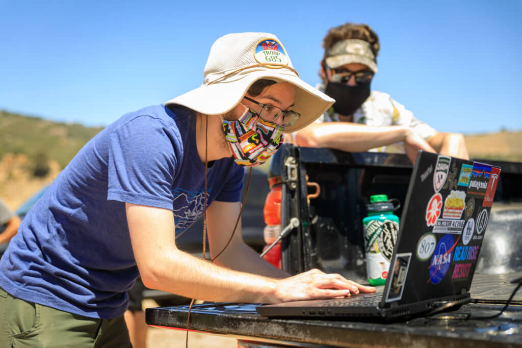 Cal Poly mechanical engineering senior Andrew Fleming checks the software for his team's research vessel at Lake Nacimiento. The raft will be on display at the virtual Project Expo.