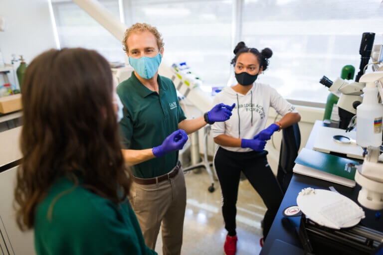Biomedical Engineering Professor Trevor Cardinal, center, served as a faculty mentor for a Summer Undergraduate Research Project with student Rayana Gutierrez, left, and Tori Barrington.