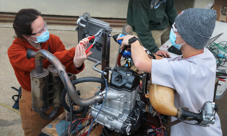 Students working on car