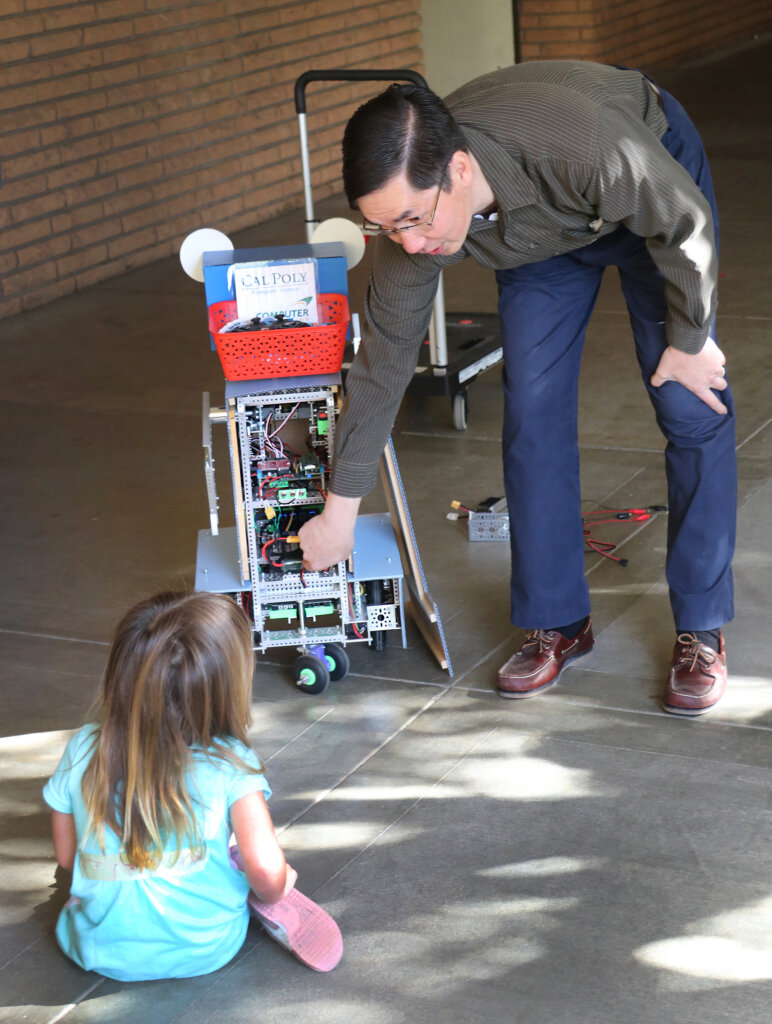 Computer Science Professor John Seng demonstrates the inner workings of his robot Herbie to pre-school students from the Cal Poly Children's Center on Monday, Oct. 31, 2022.
