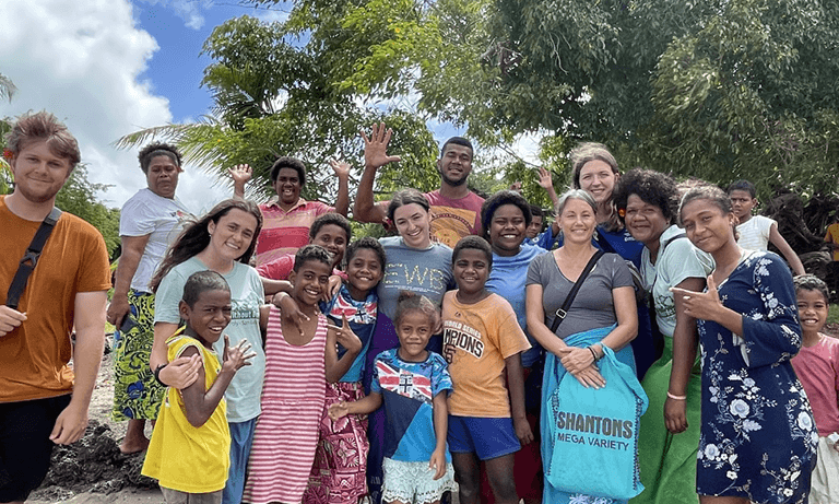 The Cal Poly Engineers without Borders Fiji team members pose for a picture with a group of locals.