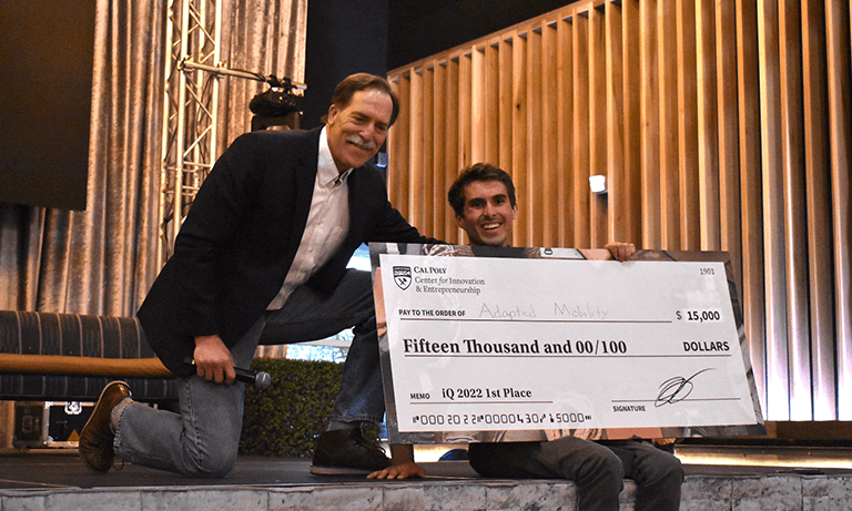 The 2022 Innovation Quest Winner accepting his check.