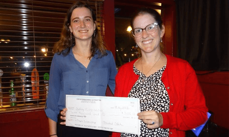 Materials engineering student Sydney Fultz-Waters receives a scholarship check from ASM.