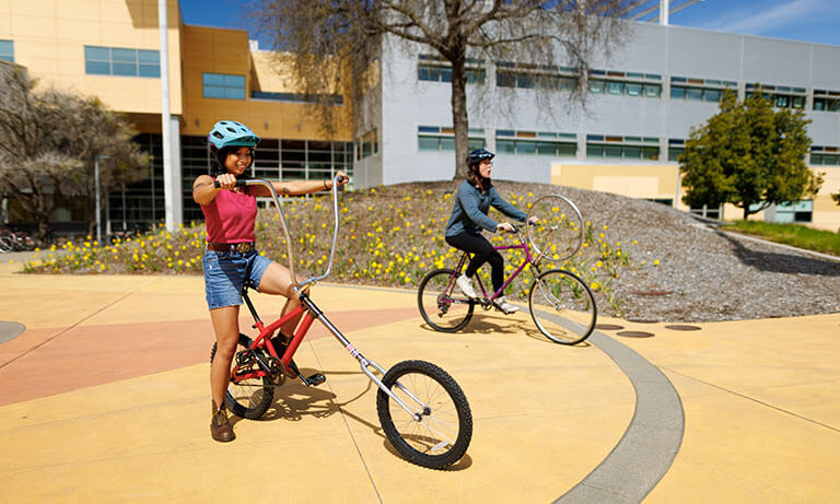 Two students on bikes.
