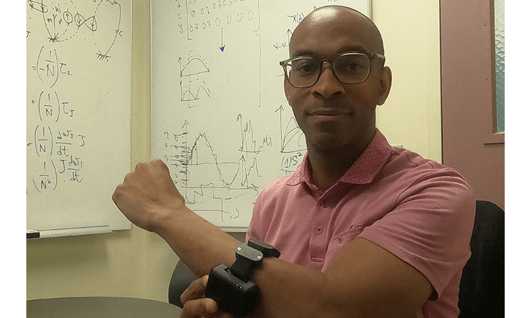 A professor wearing a data-tracking wrist device
