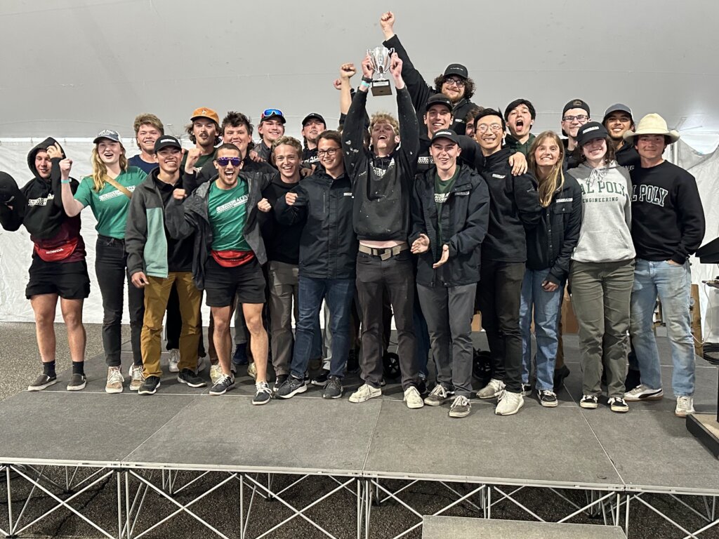 Cal Poly Racing Formula SAE team holds up the trophy
