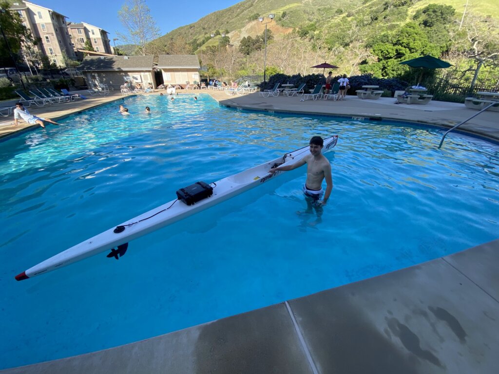 Student takes out the kayak in the Poly Canyon Village pool