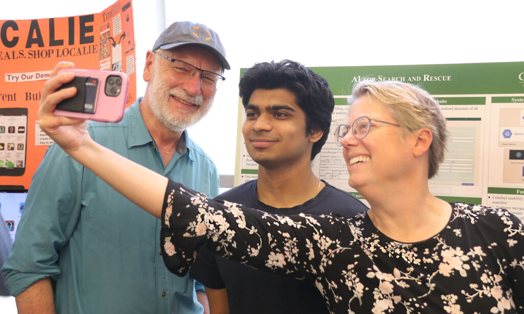 College of Engineering dean takes selfie with professor and student