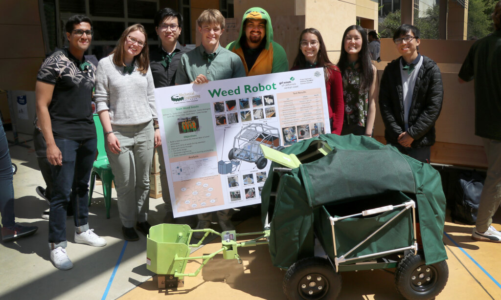 Students stand with their weed robot at the Engineering Project Expo