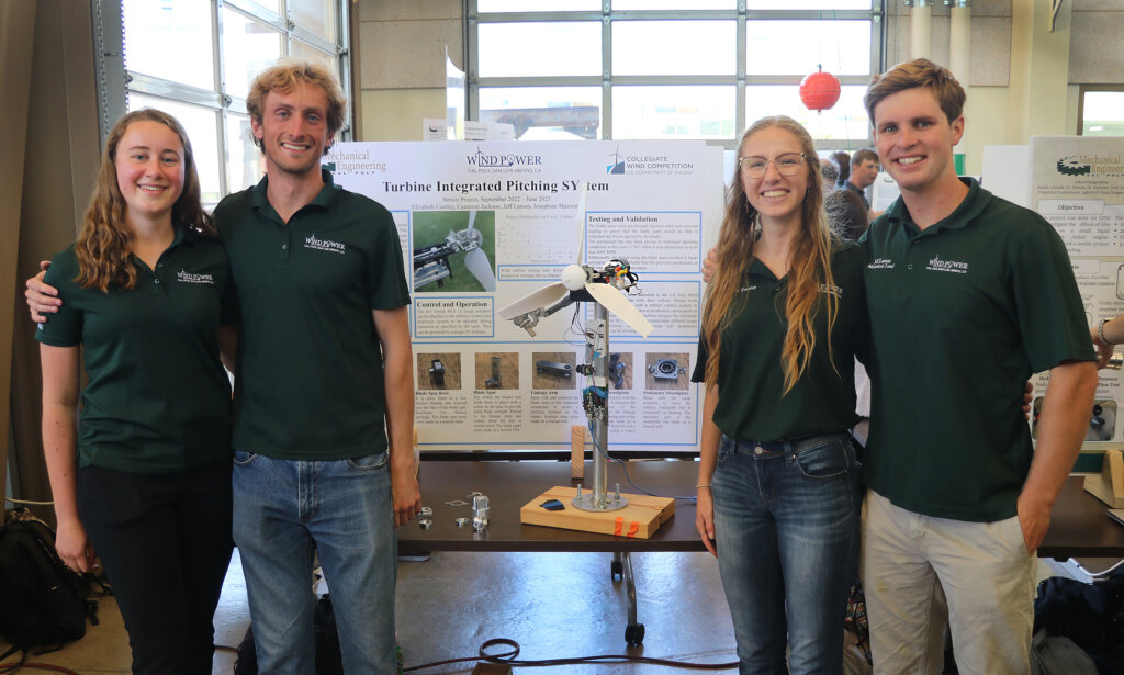 Students stand with their wind turbine project