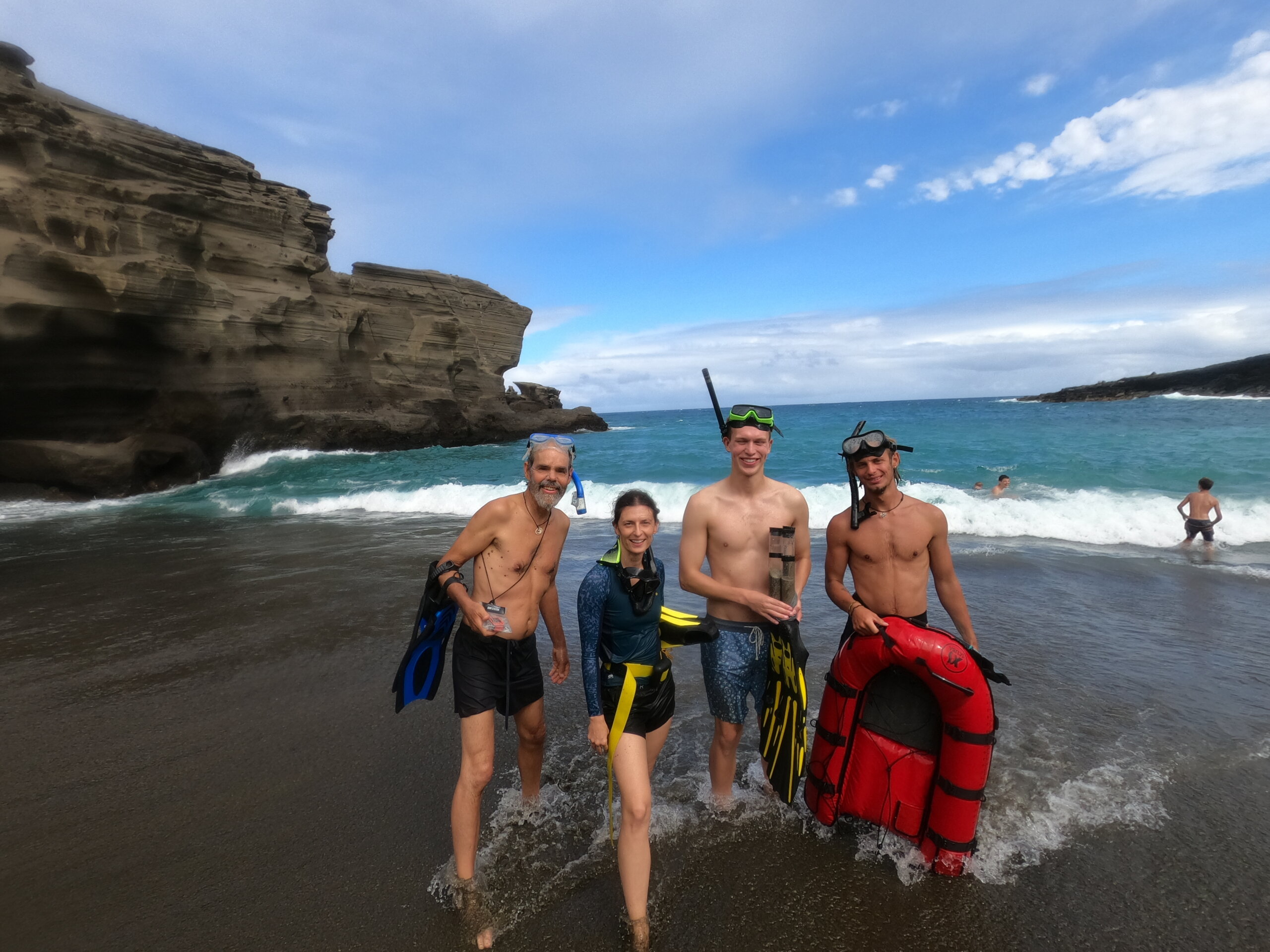 A group of researchers, including a Cal Poly professor and two students, pause after an underwater dive in Hawaii
