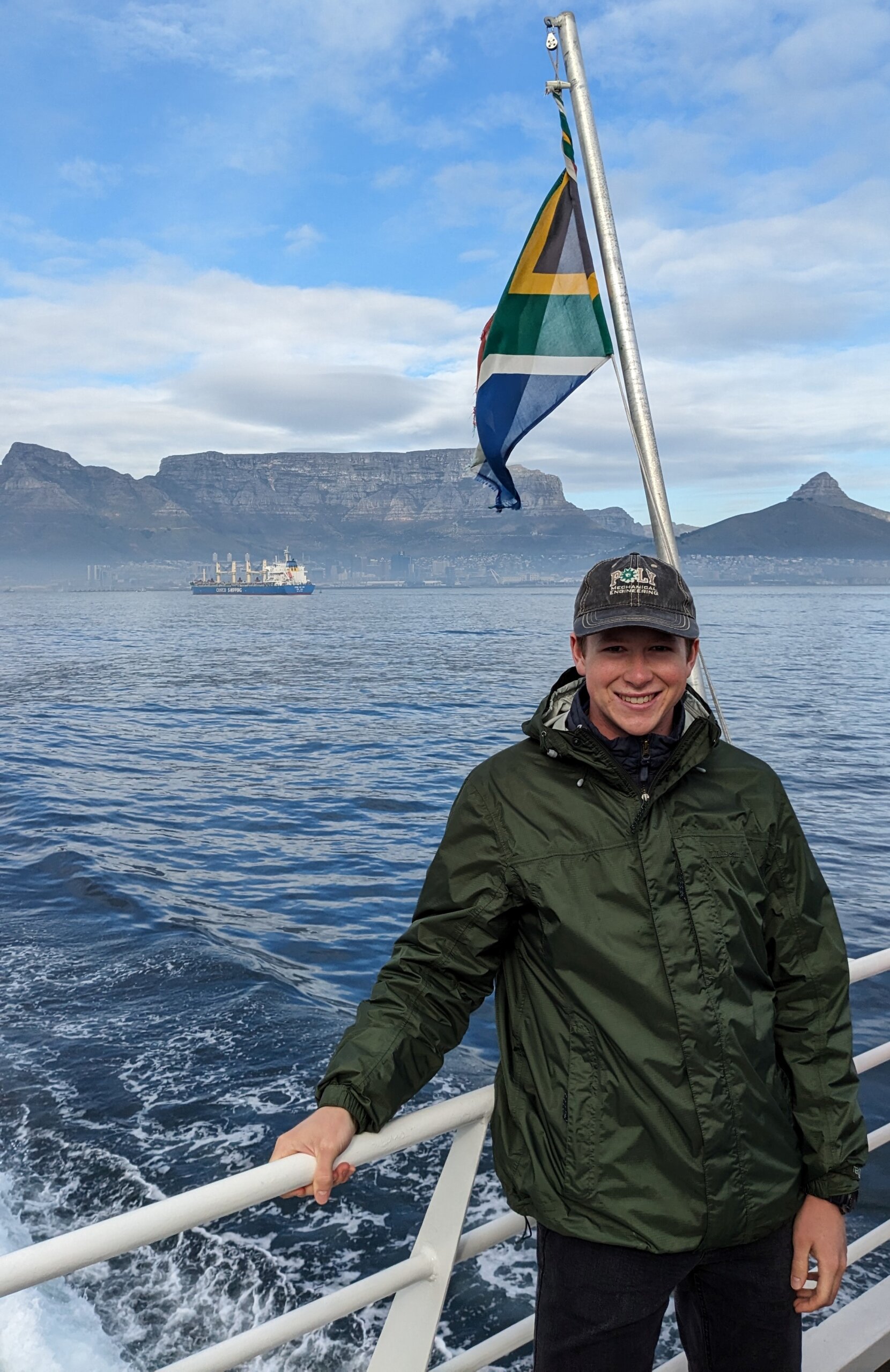 Cal Poly student takes boat ride in South Africa with Table Mountain in the background