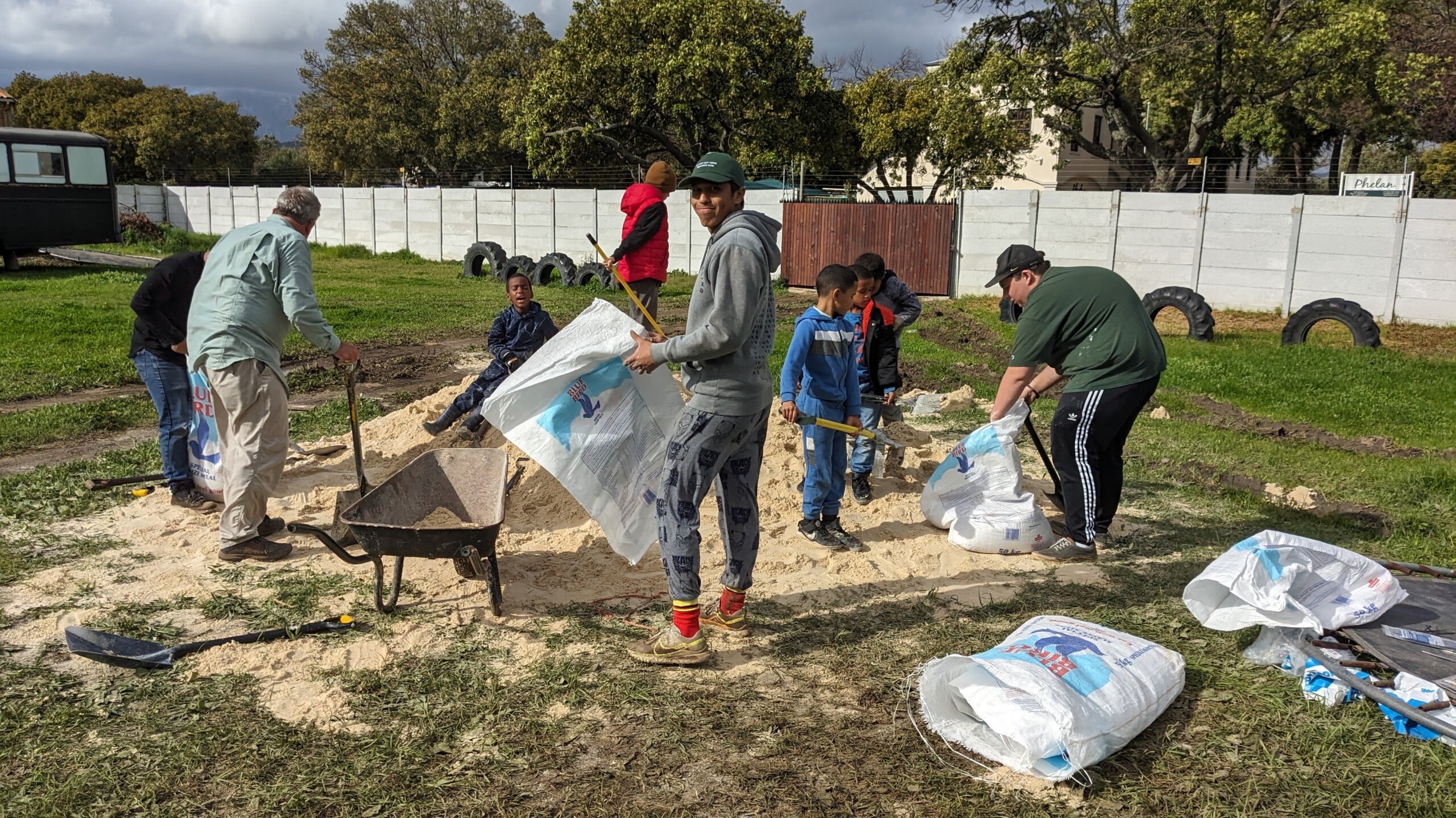 Cal Poly students fill sandbags with help from local South African children 