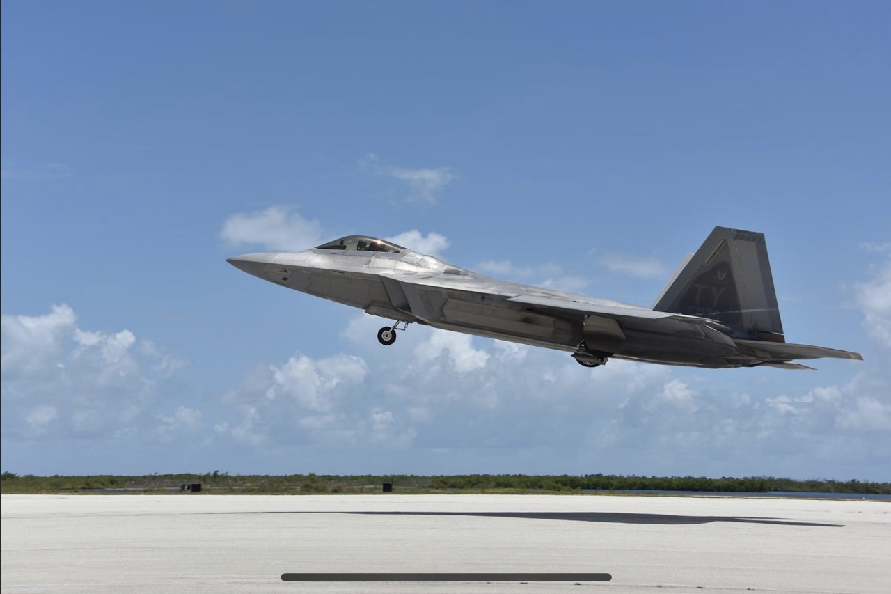 An F-22 Raptor takes off for an air combat training mission
