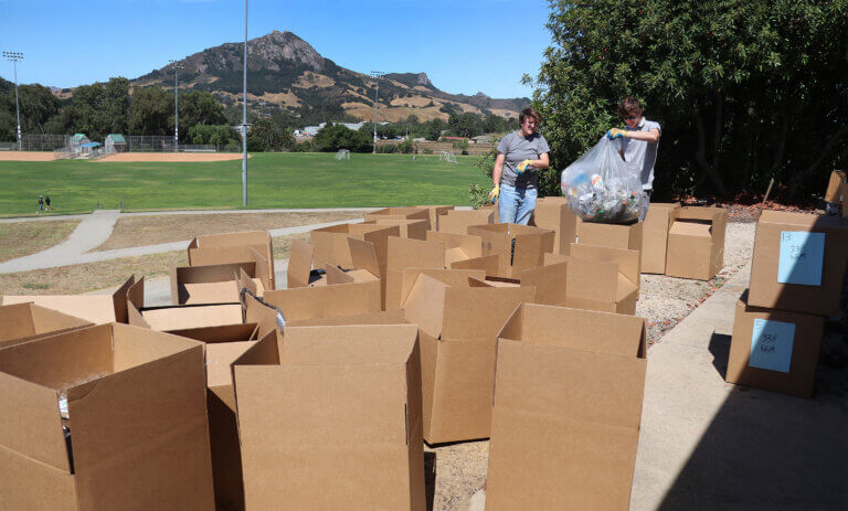 Two students surrounded by empty boxes
