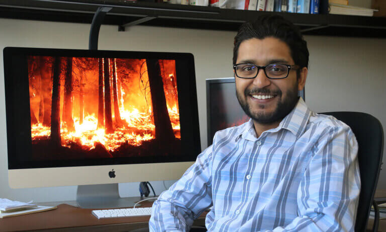 Professor has a photo of a wildfire on his computer