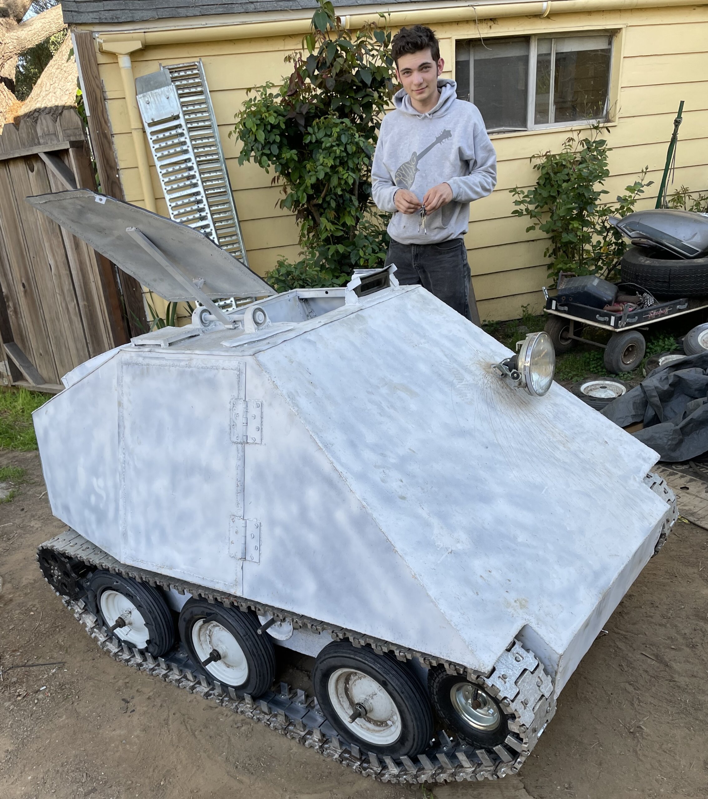 Andrew Osborn stands next to a tank he constructed