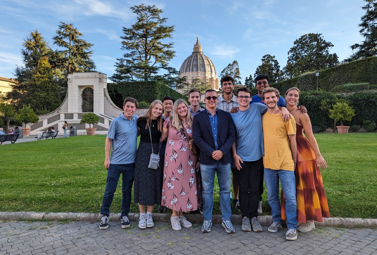 Students pose in front of the Vatican dome