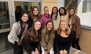 College of Engineering Dean Amy S. Fleischer posing with members of Cal Poly Society of Women Engineers