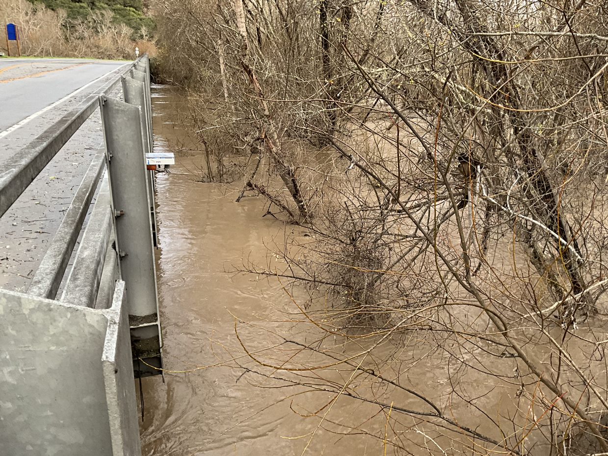 Rising creek water is measured by a tide gauge put on a bridge to record flow
