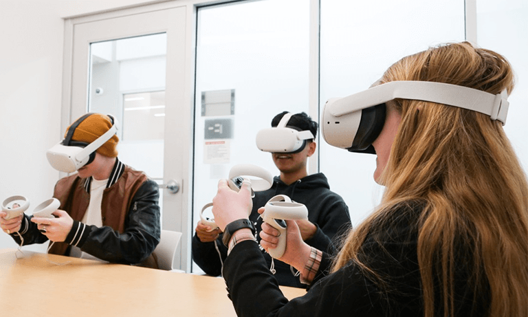 Three students with VR headsets on