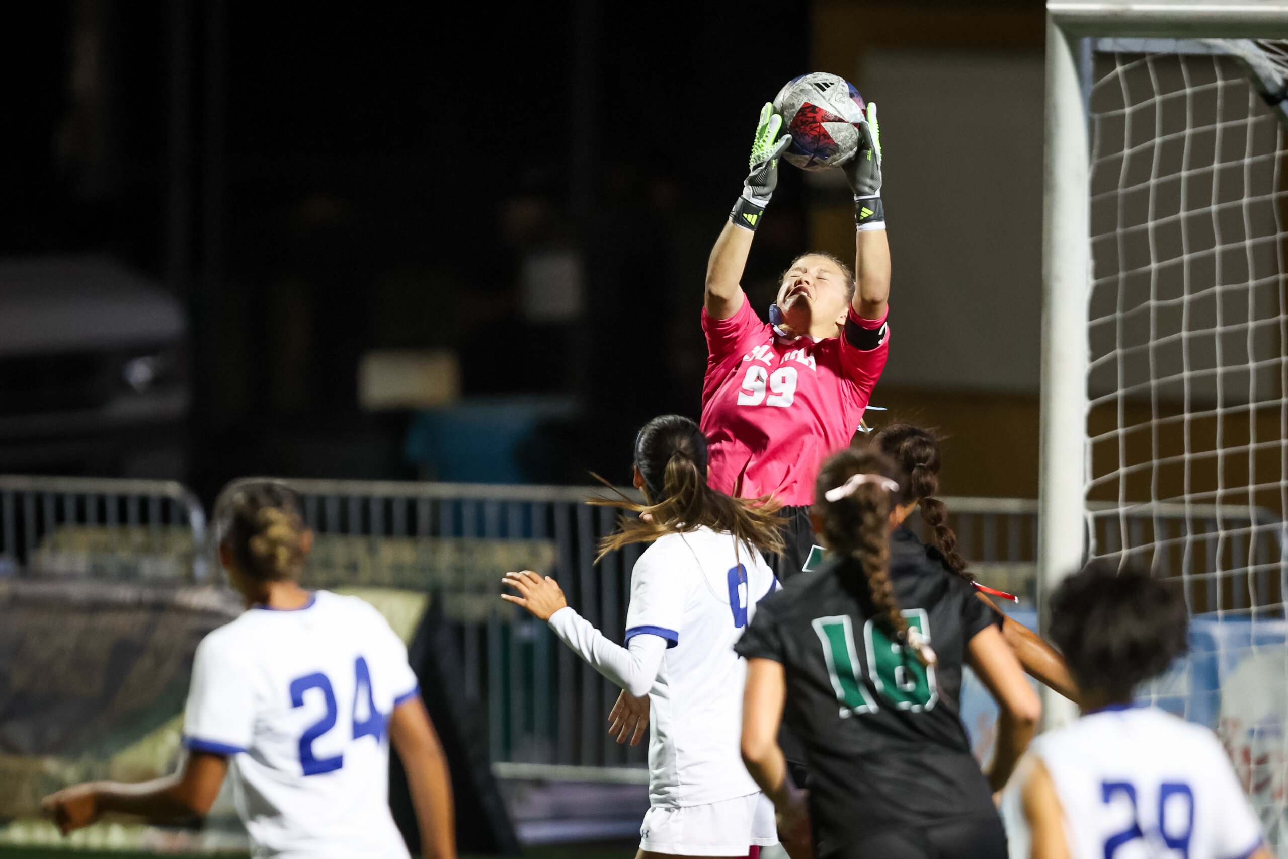 Mac Samuel makes a flying save during a soccer match at Cal Poly
