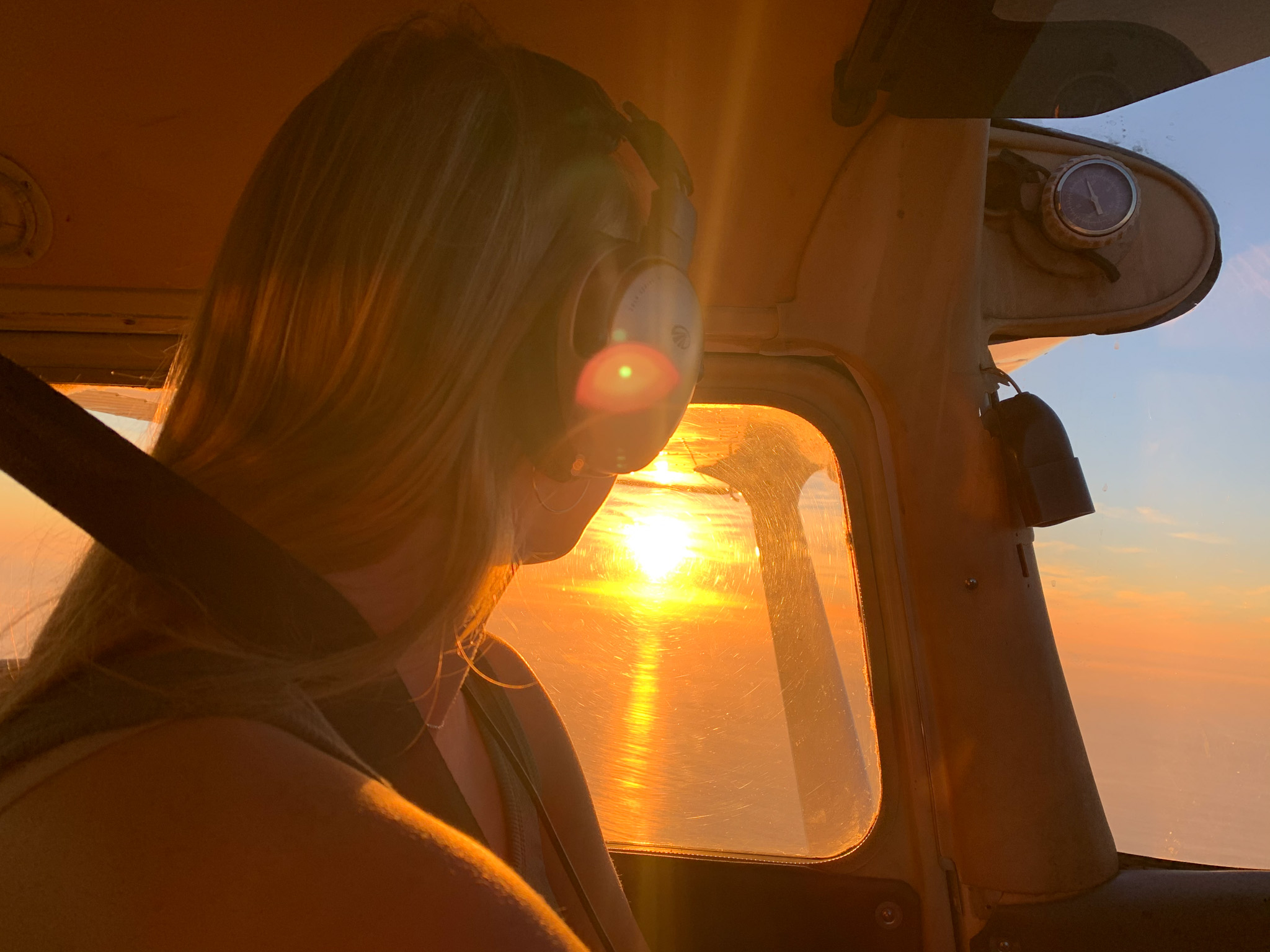 Mac Samuel gazes at the sunset from the cockpit of her plane