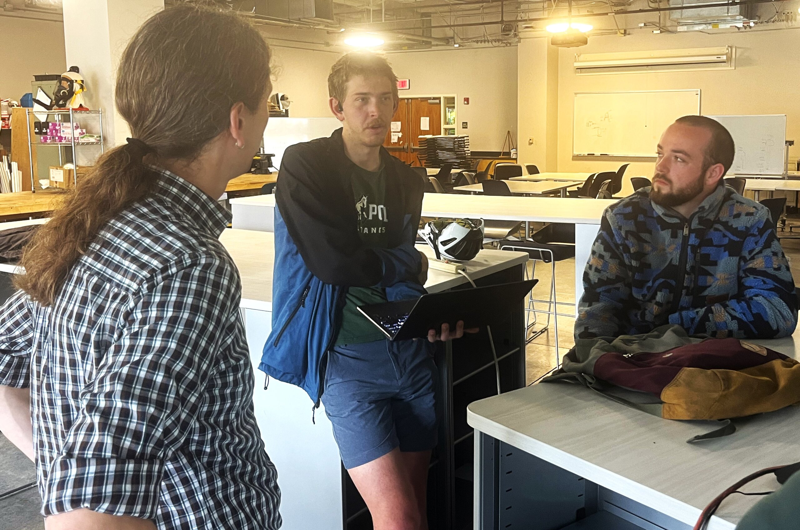 Two students and a professor discuss a senior project in the TECHE Lab