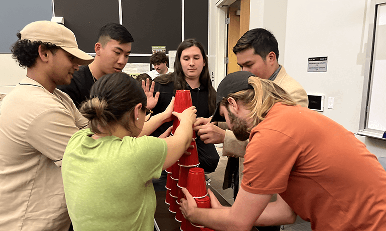 Students using red Solo cups during a team-building activity