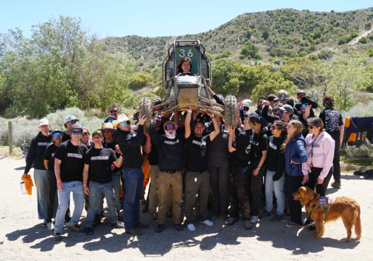 The Baja SAE team hoists their vehicle after completing their dynamic events in Gorman, California