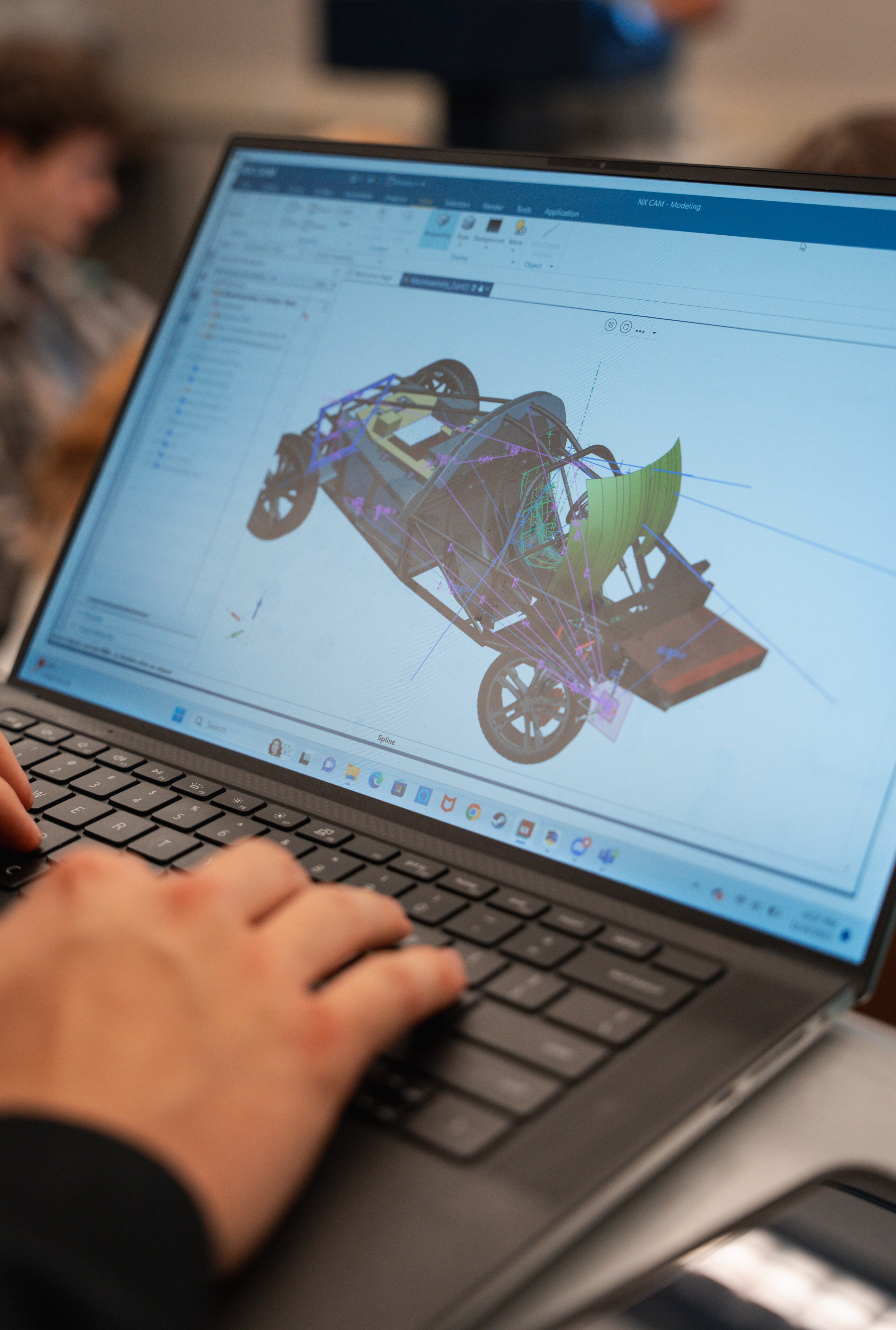 A laptop screen displays the model of the car PROVE is designing