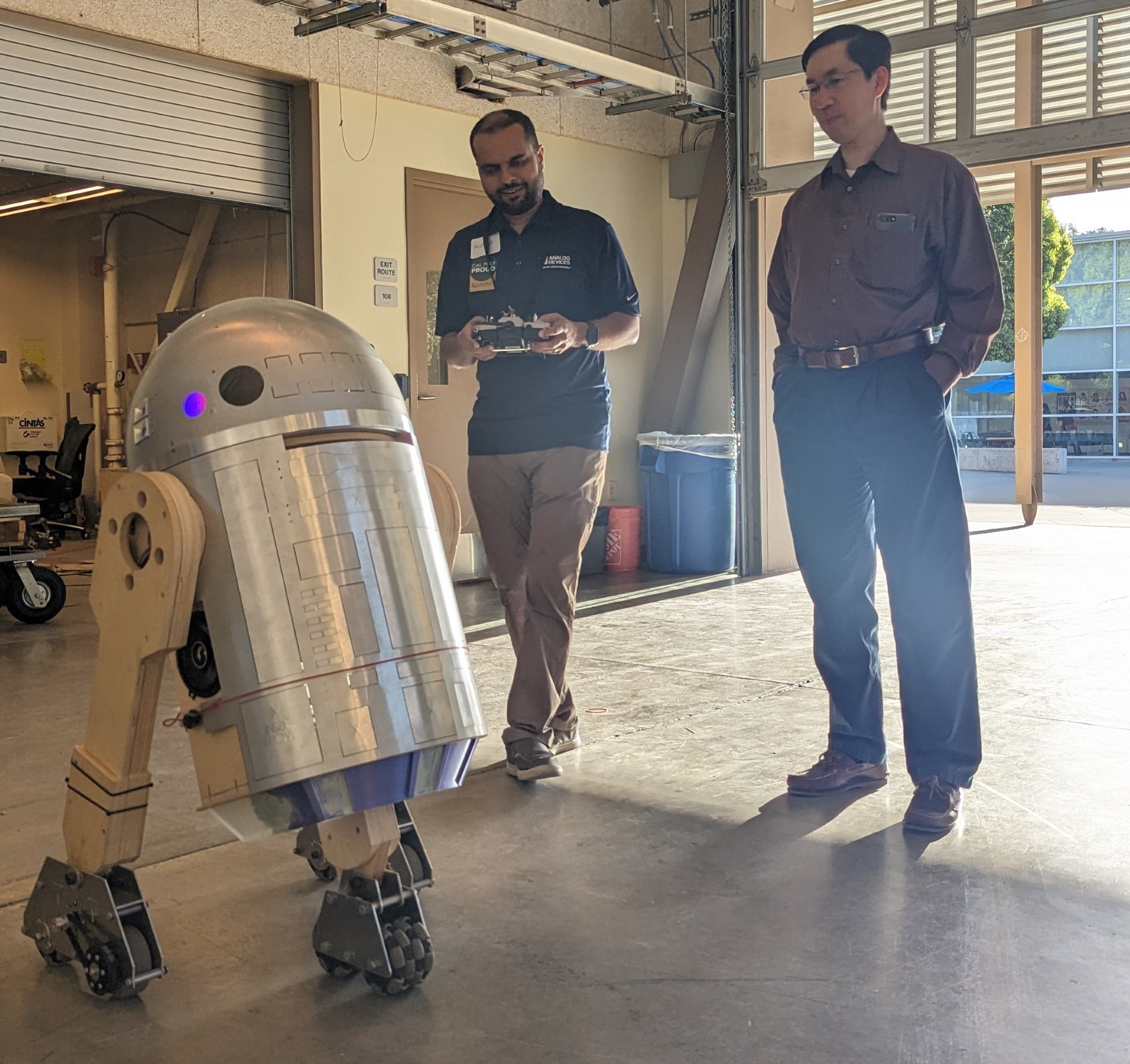Cal Poly alum operates robot Pascal with Professor John Seng observing