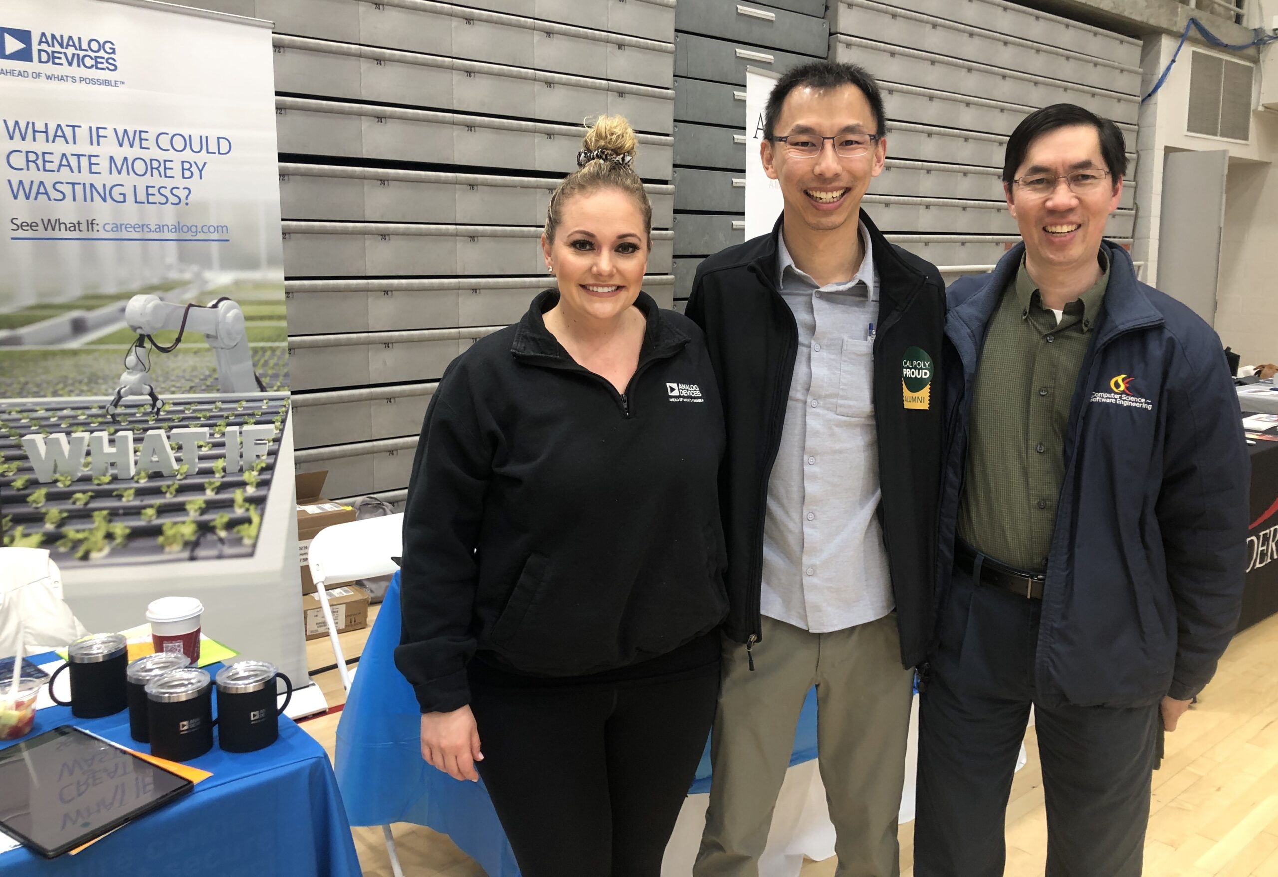 Two representatives from Analog Devices join Professor John Seng during a career fair on campus