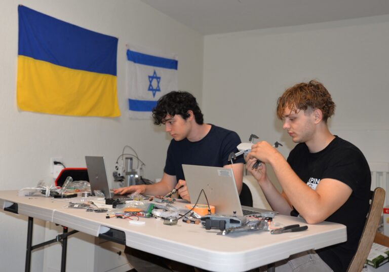 Two students work on their device that will detect whether a drone is friend or foe