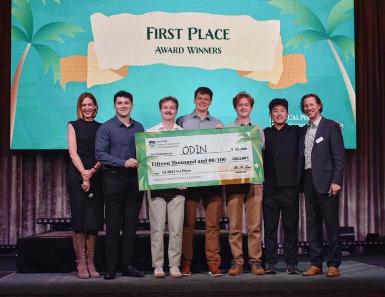 ODIN award winners hold their $15,000 check on stage