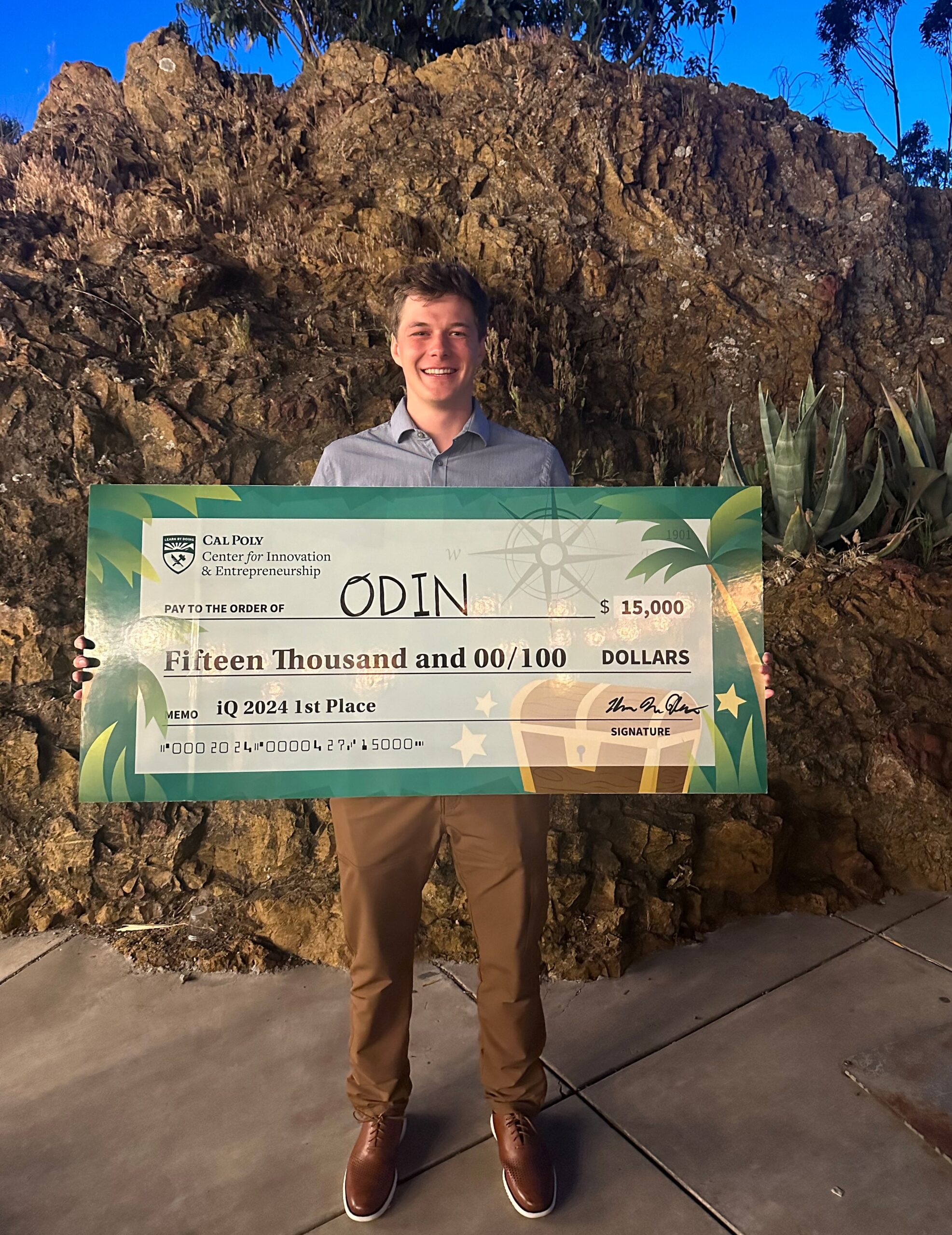 Student holds his team's $15,000 winning check