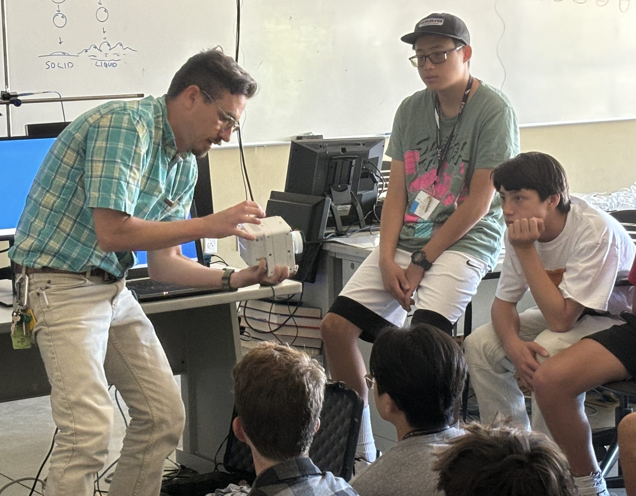 Professor shows a high-speed camera to a group of EPIC campers