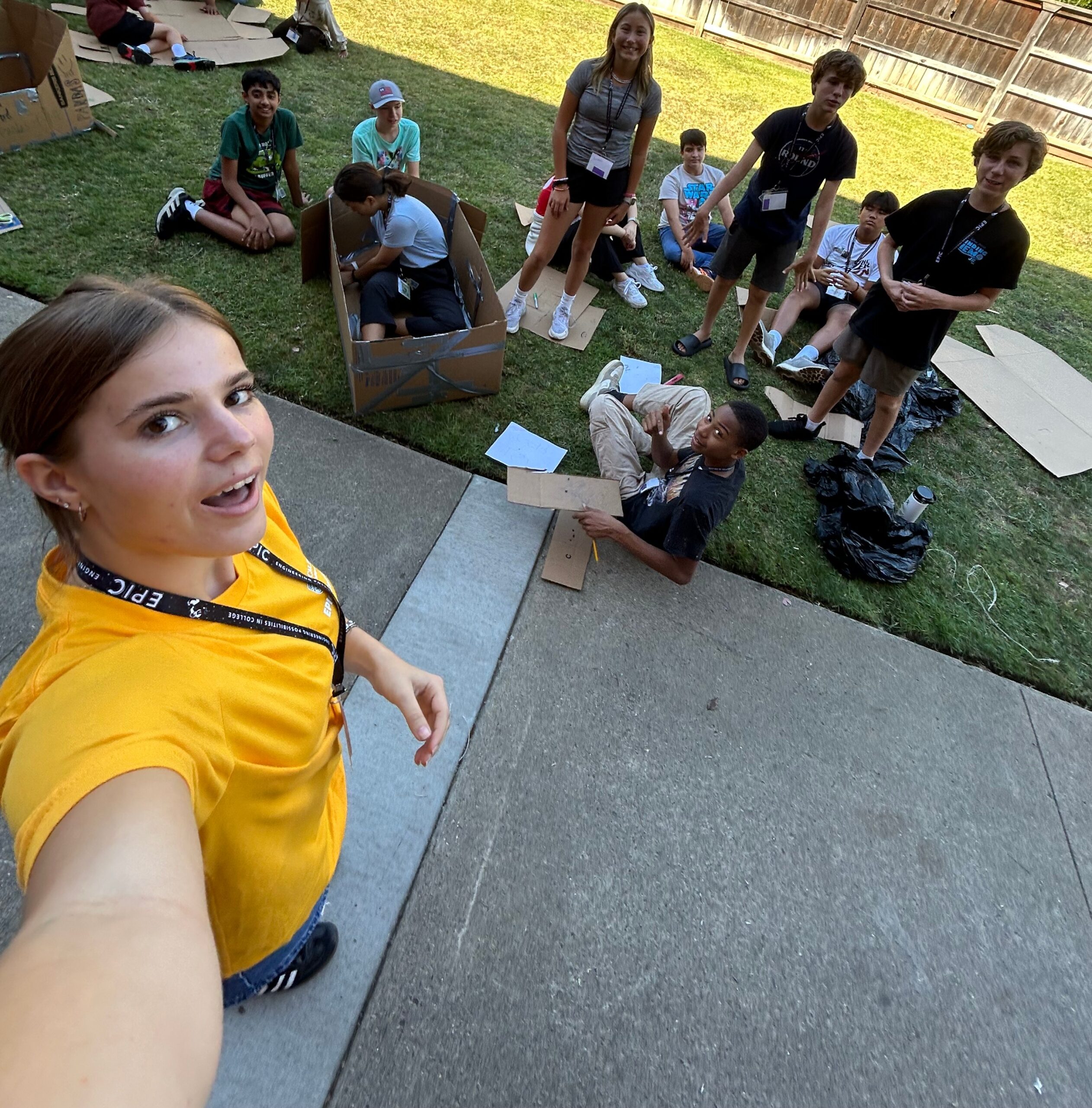 EPIC counselor takes a selfie with her group as they construct their cardboard boat