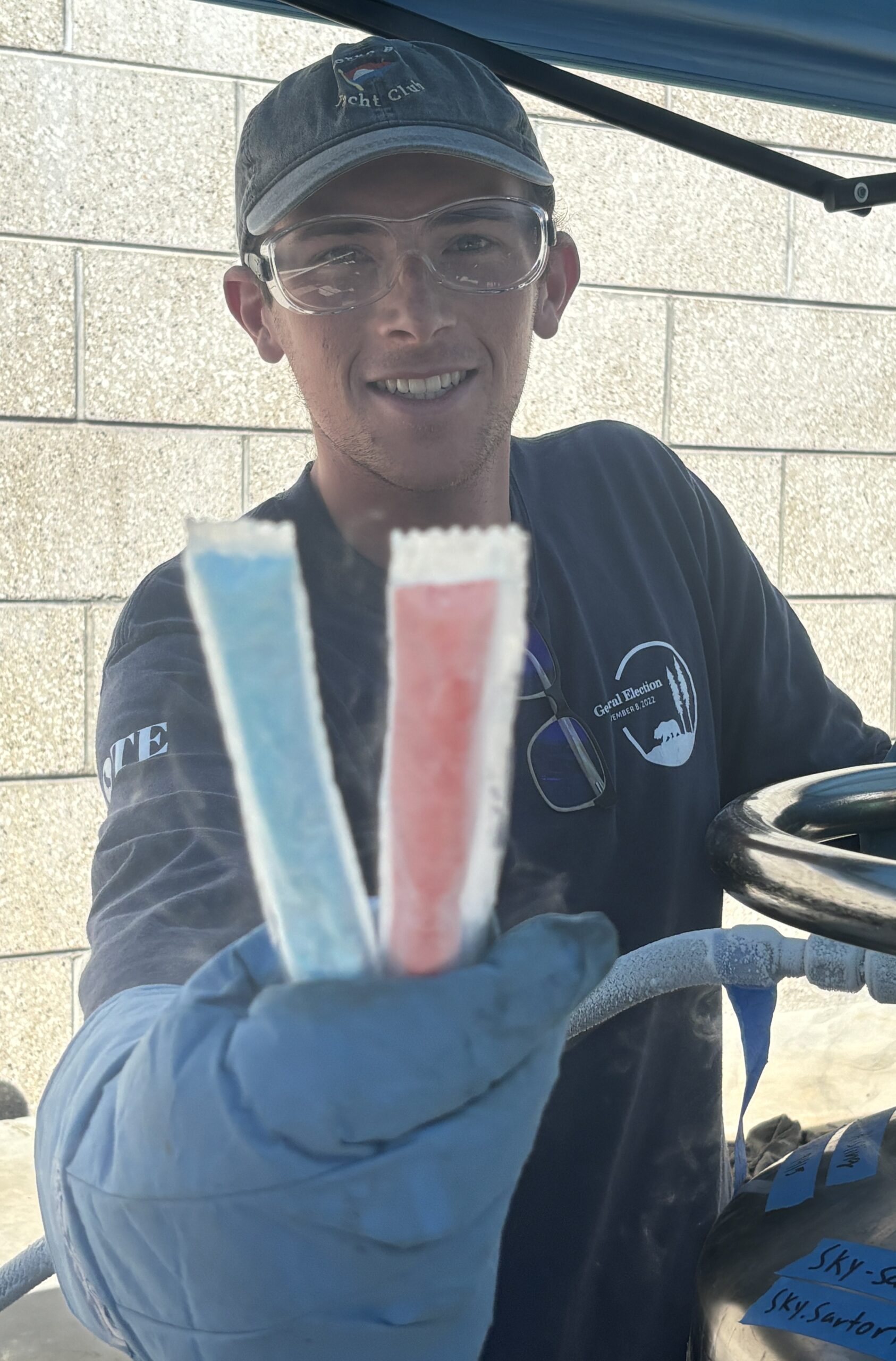 Student holds up Otter Pops frozen with liquid nitrogen