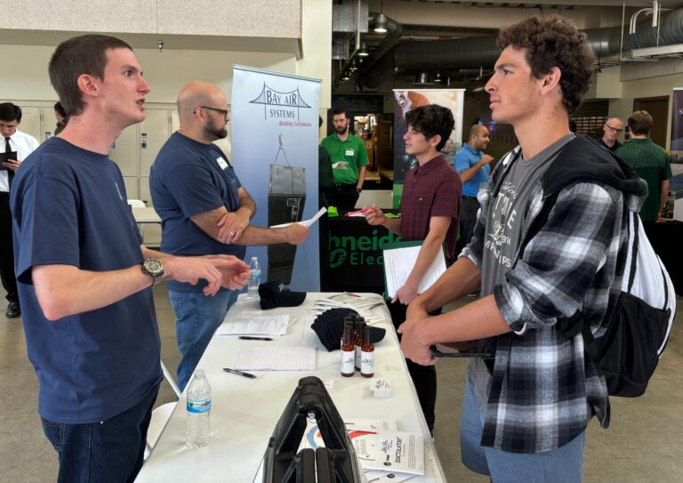 Student talks with industry rep at career fair