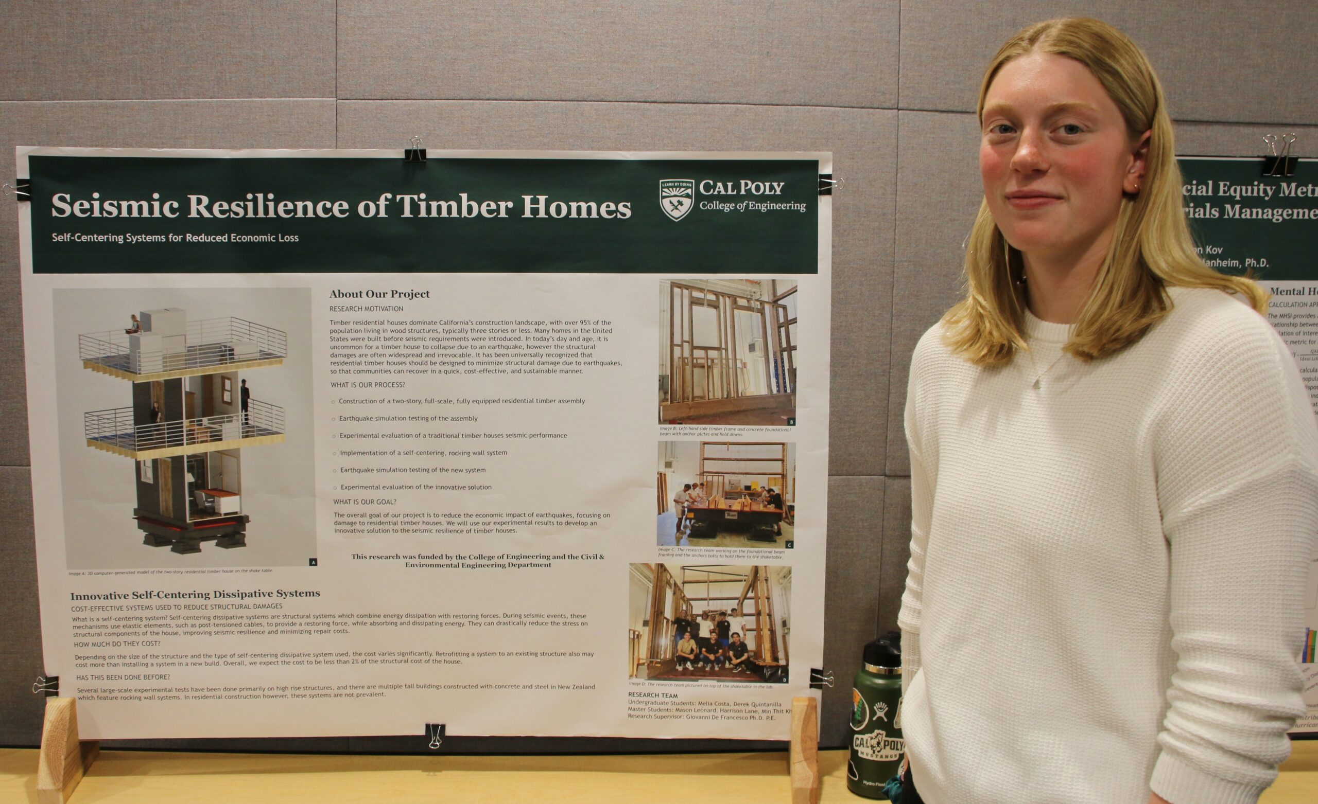 Student stands with her research poster at the SURP Symposium