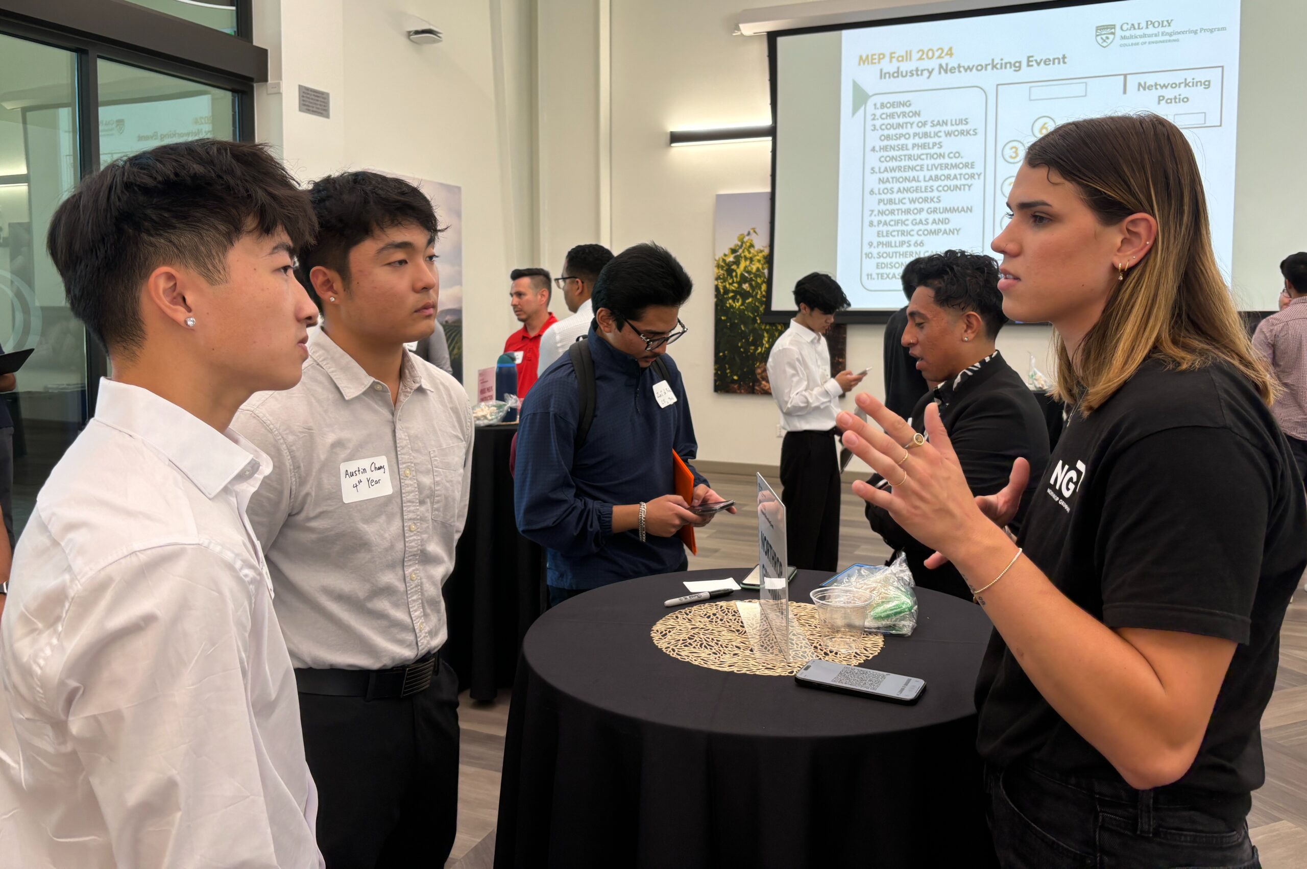 Northrop Grumman representative talks with two students