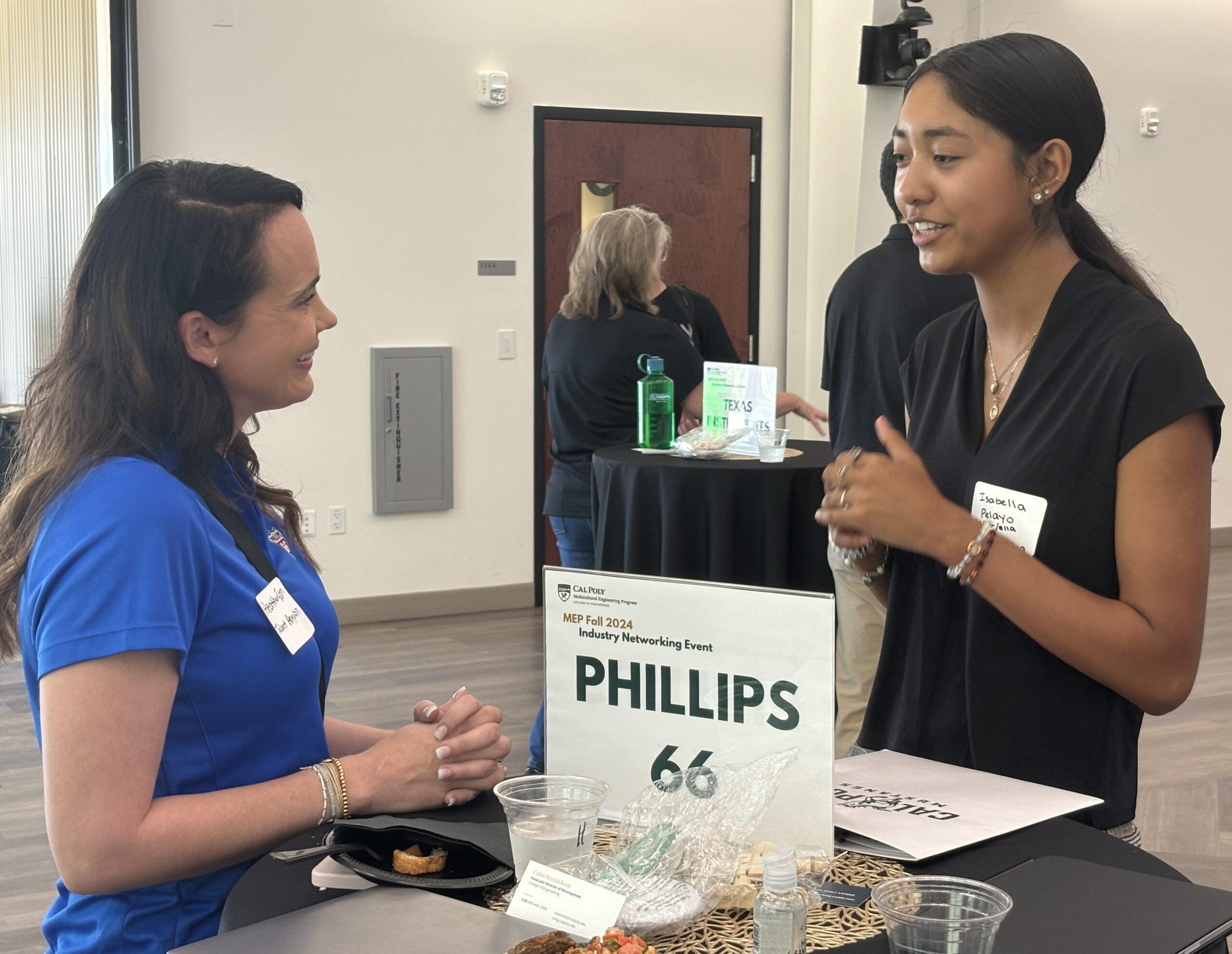 Student talks with industry professional at networking event