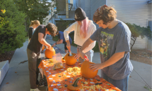 Cal Poly materials engineering students carving pumpkins.