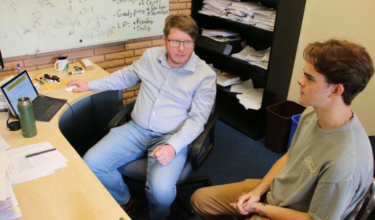 Student and professor talk in the professor's office