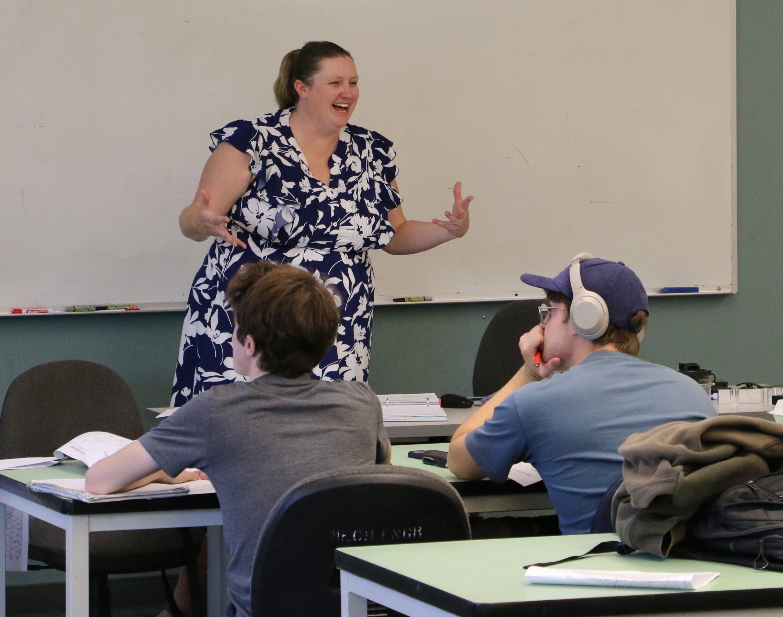 Professor instructs her students from the front of the class