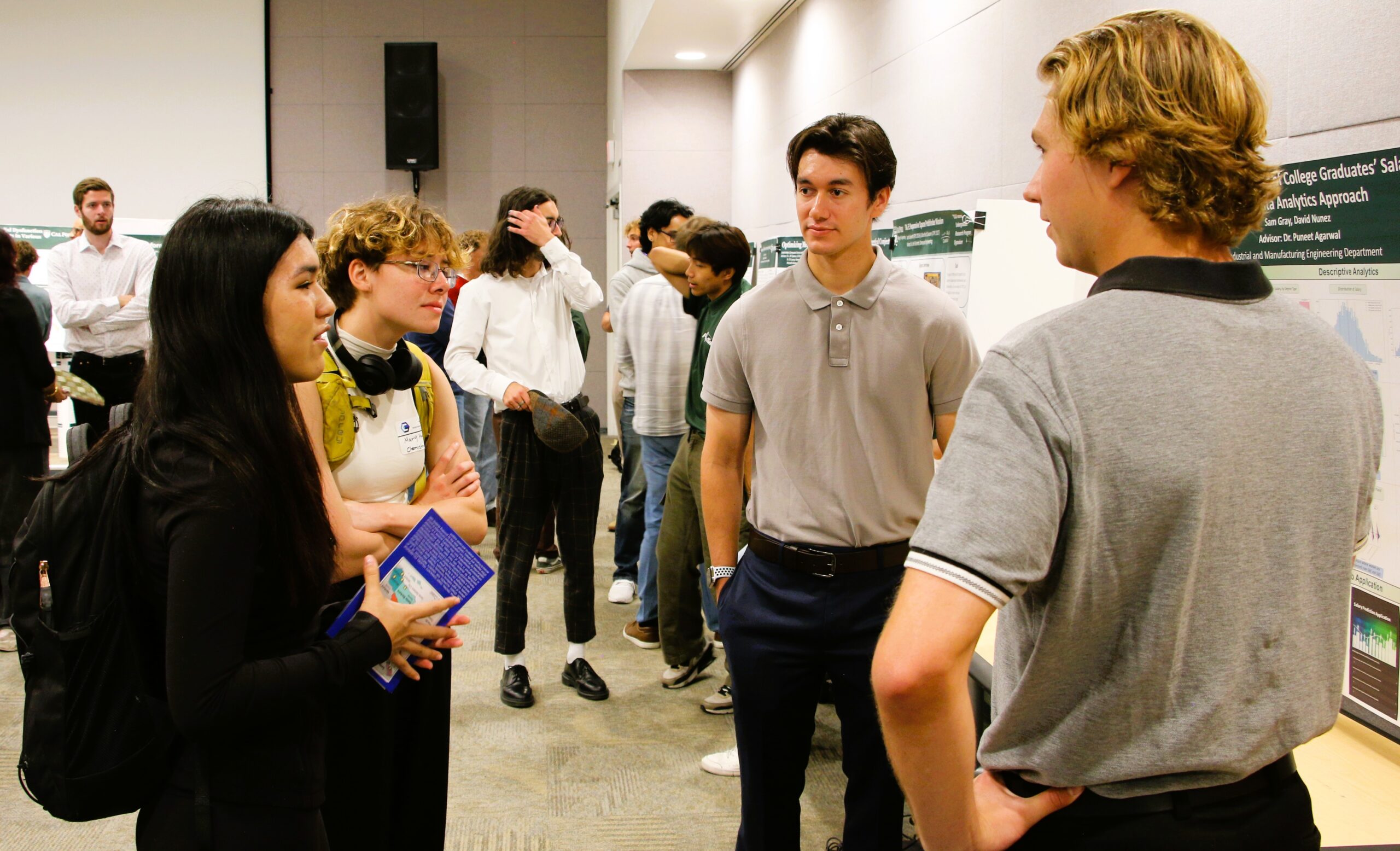 Students share their project findings with other students at sympoisum