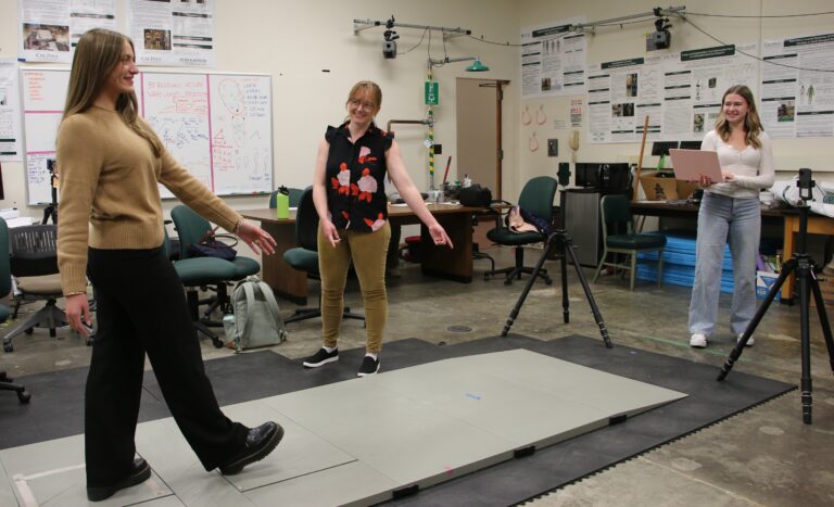 Professor directs student during gait analysis experiment