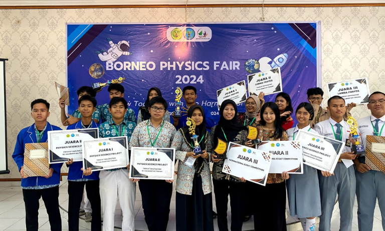 A group of students holding up their awards at a conference