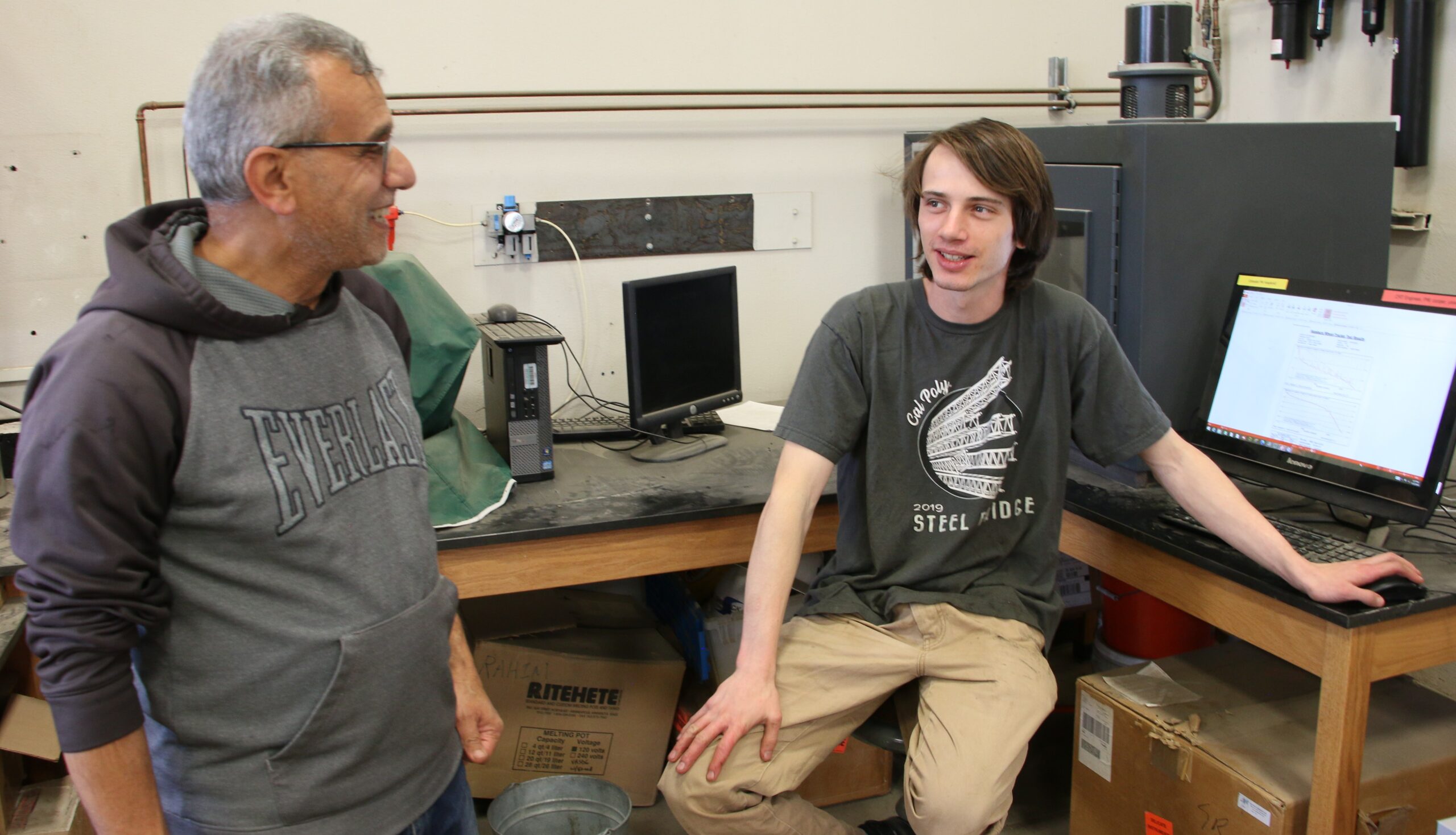 Student talks to professor about the data they collected in the Pavement Lab